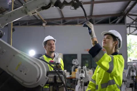 Engineer work at robotic arm factory. Stock Photos