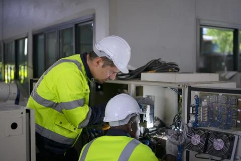 Engineer work at robotic arm factory. Stock Photos