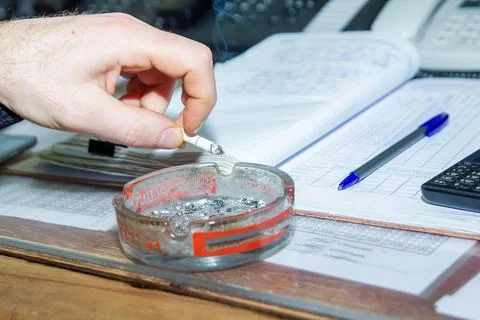 Engineer at work smoking cigarette Stock Photos