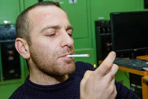 Engineer at work smoking cigarette Stock Photos
