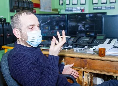 Engineer at work smoking cigarette Stock Photos