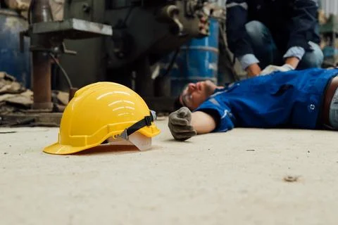Engineer worker with accident at factory Stock Photos