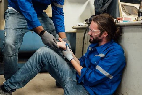 Engineer worker with accident at factory Stock Photos