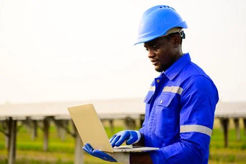 Engineer worker checking and maintaining solar panels on solar farm Stock Photos