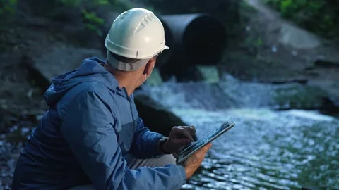 Engineer worker checking water quality of river. Wastewater treatment test Stock Footage 163920694