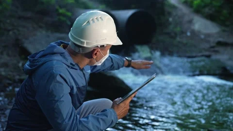 Engineer worker checking water quality of river. Wastewater treatment test Stock Footage 165464693