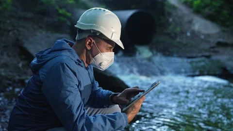 Engineer worker checking water quality of river. Wastewater treatment test Stock Footage 205112212