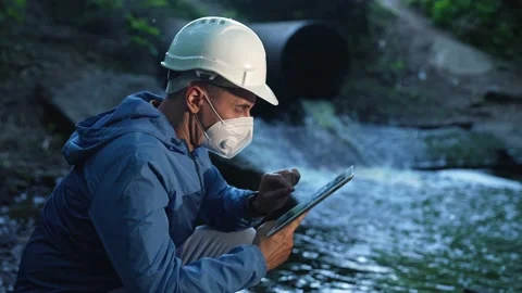 Engineer worker checking water quality of river. Wastewater treatment test Stock Footage 220833142