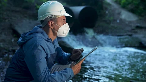 Engineer worker checking water quality of river. Wastewater treatment test Stock Footage 223531546