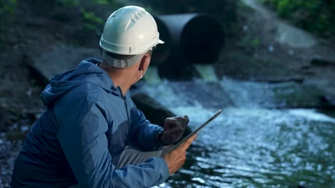 Engineer worker checking water quality of river. Wastewater treatment test Stock Footage 231323721