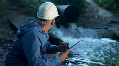 Engineer worker checking water quality of river. Wastewater treatment test Stock Footage 235887005