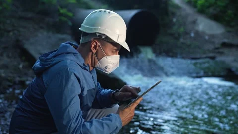 Engineer worker checking water quality of river. Wastewater treatment test Stock Footage 254078461
