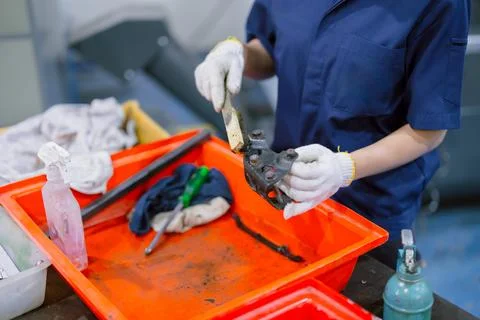 Engineer worker cleaning dirty machine part service maintenance engine gear.. Stock Photos
