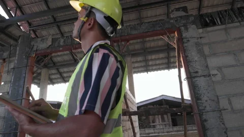 Engineer worker in a construction site building to inspecture interior Stock Footage 149916513