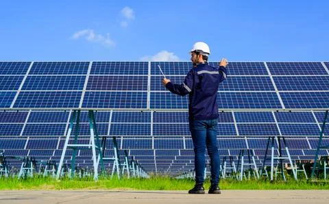 Engineer worker portrait with solar panel at solar farm 写真素材