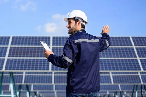 Engineer worker portrait with solar panel at solar farm Foto stock