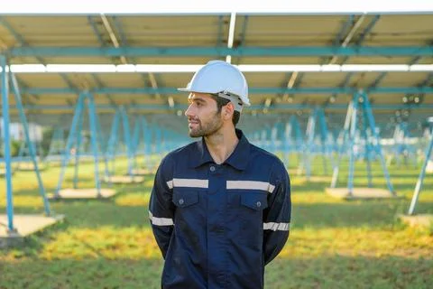 Engineer worker portrait with solar panel at solar farm Stock Photos