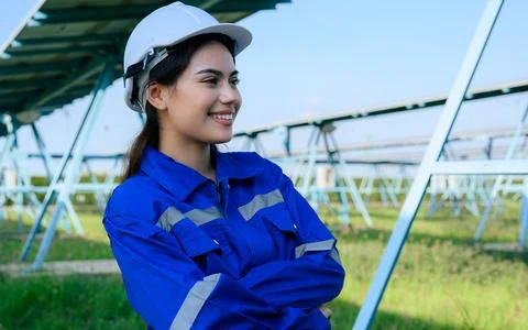 Engineer worker portrait with solar panel at solar farm Stock Photos