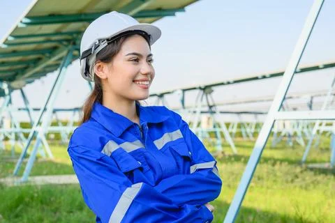 Engineer worker portrait with solar panels at solar farm Stock Photos