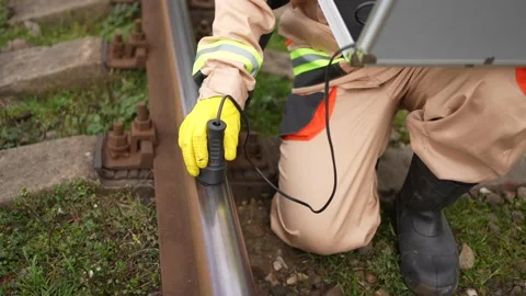 Engineer worker search for defects in railway railway sleepers and steel rails Stock Footage 235806549