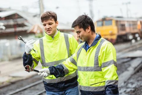 Engineer worker skill labor team friend working at train depot service main.. Foto stock
