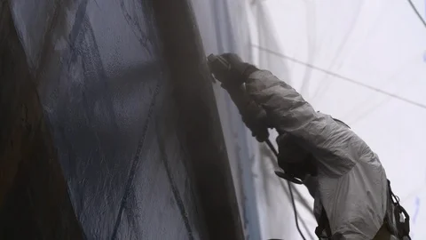 Engineer worker using sander machine for sanding metal surface of boat Stock Footage 116511054