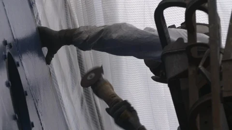 Engineer worker using sander machine for sanding metal surface of boat Stock Footage 116511214