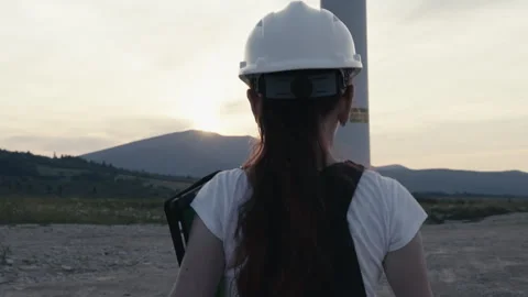 An engineer worker wearing a white helmet and with a tablet in his hands goes to Stock Footage 246178210