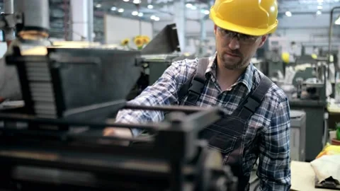 An engineer, a worker working on a milling machine. Manufacture of cutting tools Stock Footage 171775628