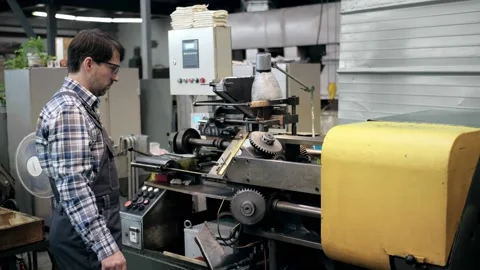 An engineer, a worker working on a milling machine. Manufacture of cutting tools Stock Footage 171775675