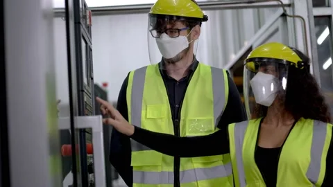 Engineer workers with face mask and face shield protection checking machine. Stock Footage 154917467