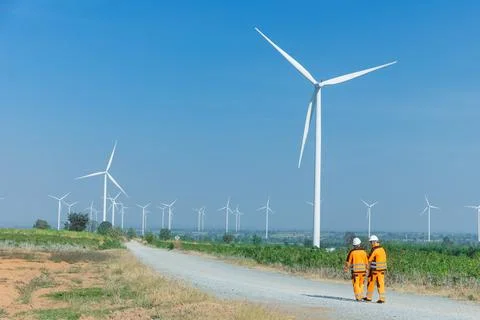 Engineer workers teamwork working together service maintenance wind turbine.. Stock Photos