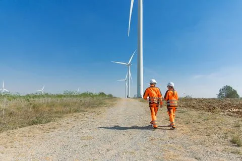 Engineer workers teamwork working together service maintenance wind turbine.. Stock Photos