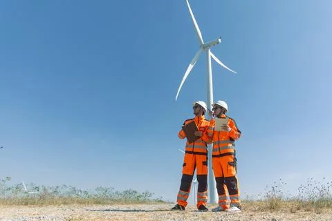 Engineer workers teamwork working together service maintenance wind turbine.. Stock Photos