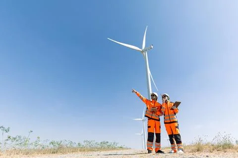 Engineer workers teamwork working together service maintenance wind turbine.. Stock Photos