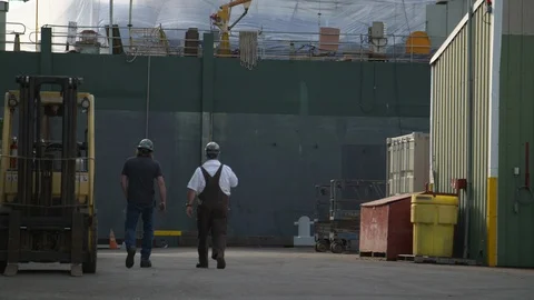 Engineer workers walking away at shipyard after work Stock Footage 116513933