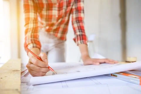 Engineer working alone at construction property site. Architecture with proje Фото