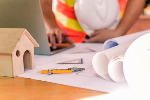 Engineer working alone at construction property site. Architecture with proje Фото