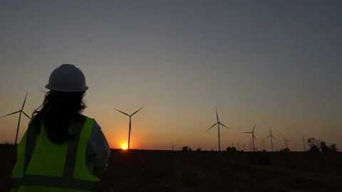 Engineer working and holding the report at wind turbine farm Power Stock Footage 138376732
