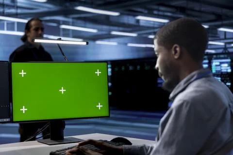 Engineer working at chroma key PC to prevent damages in server farm Stock Photos