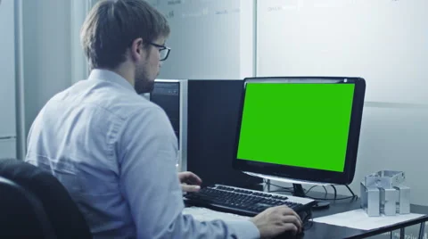 Engineer is Working on Computer. Display with Green Screen Stock Footage 46994292