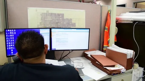 Engineer working at computer with dual monitors Video stock 83804875