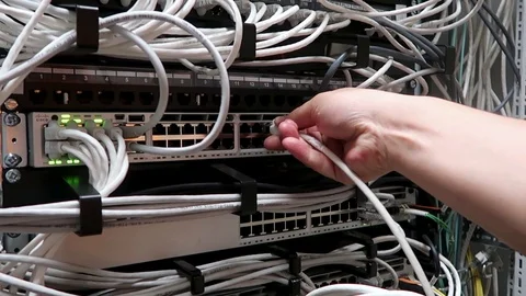 Engineer working in a data center. Male hand inserts the date cable router Stock Footage 105124115