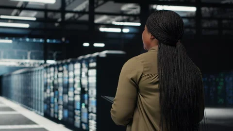 Engineer working in data center managing and optimizing network Stock Footage 317124497