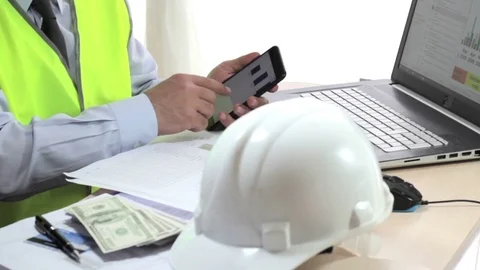 Engineer working at desk, examining reports. Video stock 75423435