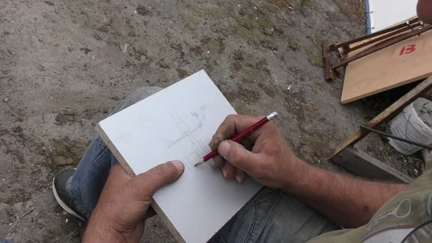 An engineer is working on a drawing of a mechanism assembly. Stock Footage 115591093