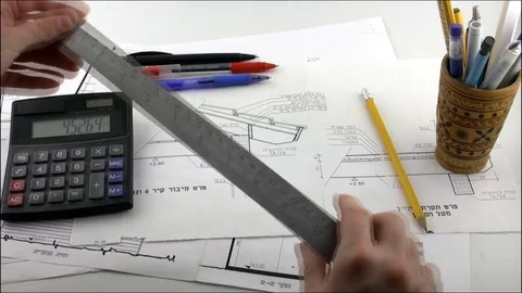 Engineer working with drawings of home Stock Footage