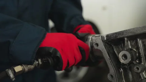 Engineer Working on Engine Block with Pneumatic Tool in Industrial Workshop Stock Footage 302192692