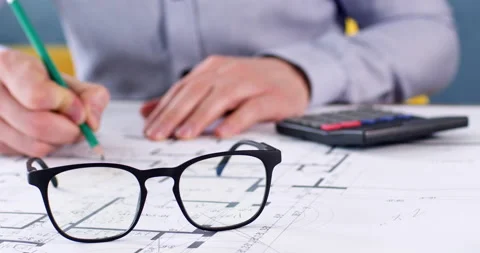 Engineer working with exact counts on paper drawing Stock Footage 234641127