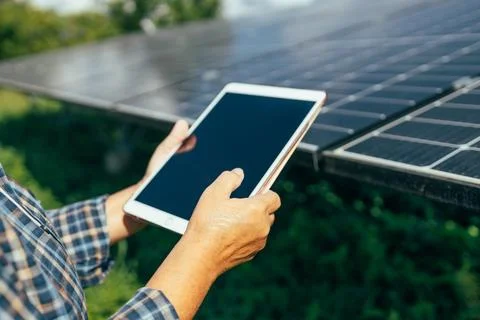 Engineer working at floating solar farm. Solar panels checking the panels at Stock Photos